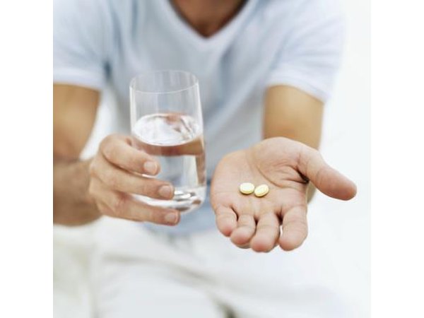 Glass of water and aspirin pills