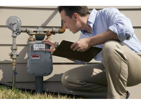 man inspecting water meter