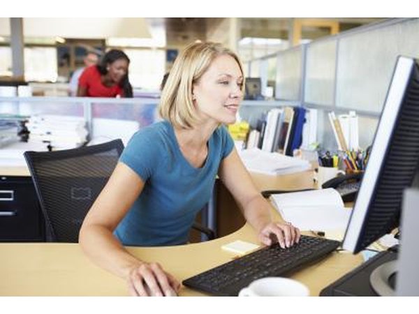 Woman researching on a desktop computer