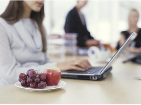 Woman working next to fruit plate