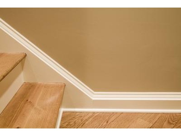 Use molding and paint to create stairway baseboards.