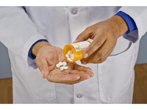 Doctor pouring pills from bottle