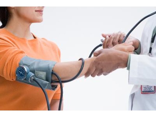 Doctor taking patient's blood pressure.