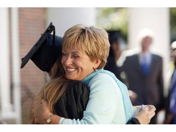 Mom hugging graduate