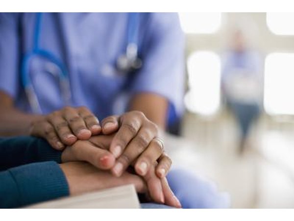 Nurse holding hands of patient