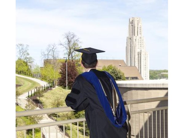 Doctorial graduate looking over the Cathedral of Learning at the University of Pittsburgh