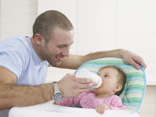 Father giving milk to baby