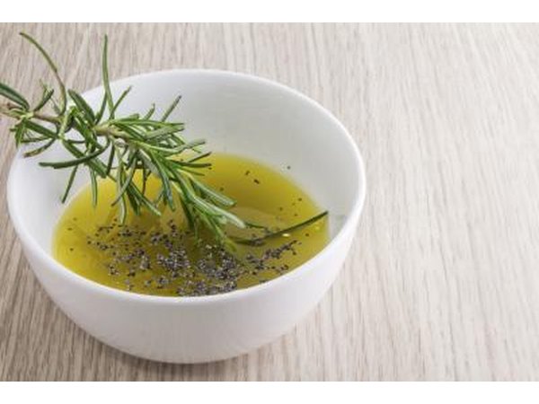 A small bowl of olive oil and rosemary.