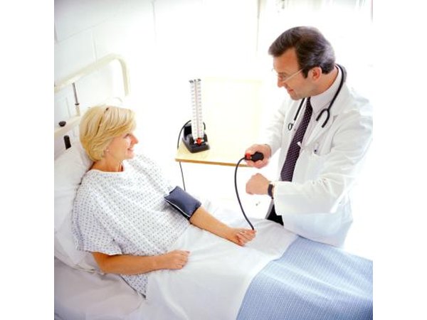 A woman has her blood pressure checked before a colonoscopy procedure.