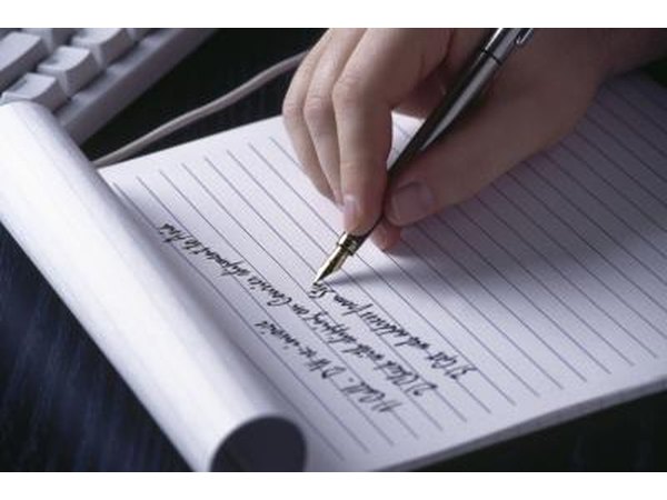 man writing down list