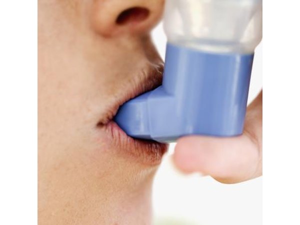 Woman taking inhaler
