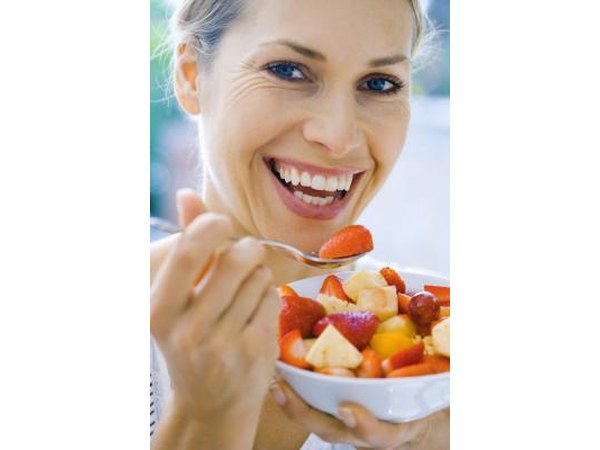Woman eating a bowl of fruit