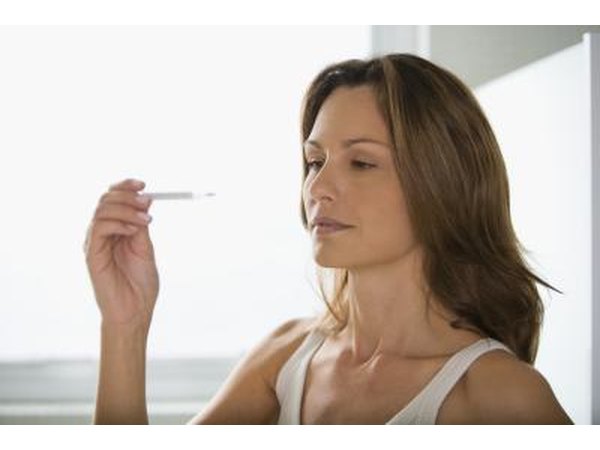 Woman looking at thermometer