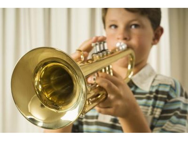 little boy playing the trumpet