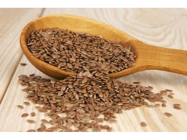 Flaxseed spilling from a wooden spoon