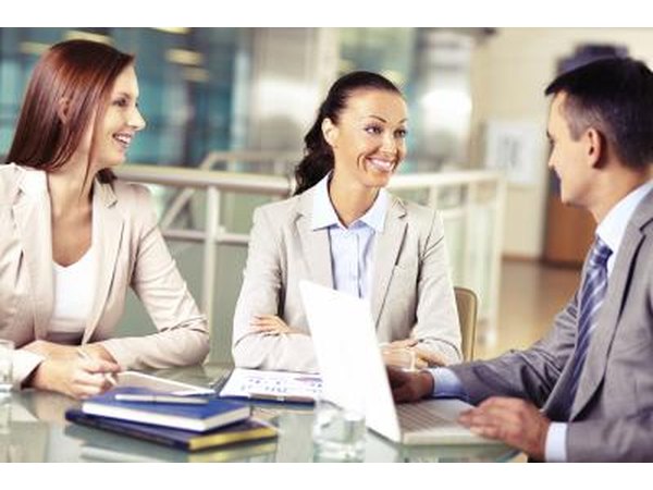Business owner meeting with employees.