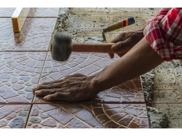 The installation of a mosaic floor using stone tiles.