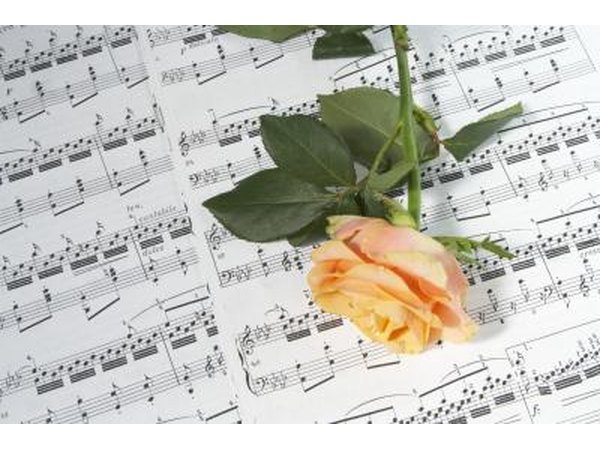 Rose on sheet music with song lyrics.