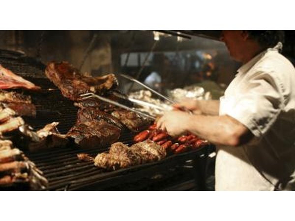 Chef grilling steaks in Argentina.
