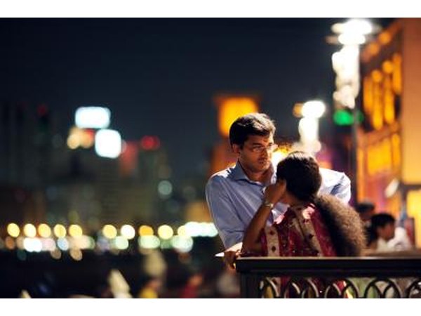 Couple talking by Dubai River in Dubai, UAE