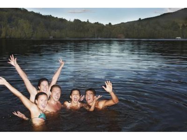 a group of friends in a lake in bathing suits