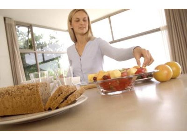 Woman eating in kitchen