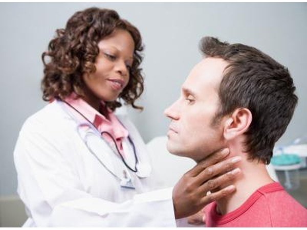 doctor checking man's thyroids