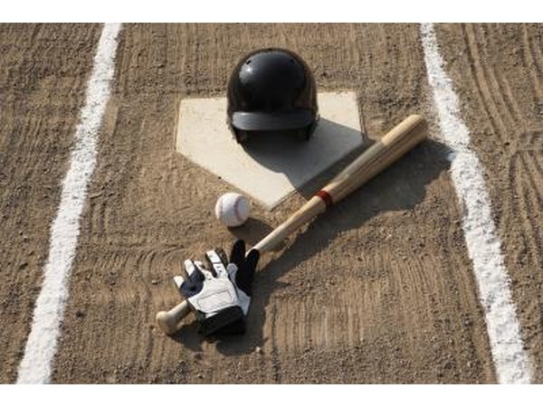 A softball, glove, bat, and batting glove.