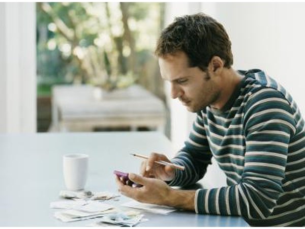 A man sitting with a calculator