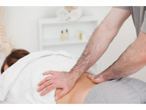 Physical therapist working on back.