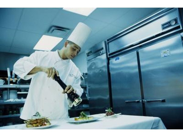 Chef working in front of a large refrigerator