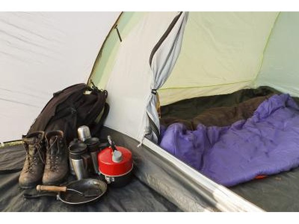 Assortment of camping gear next to tent