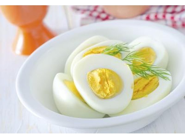 A bowl of hard boiled eggs cut in half.
