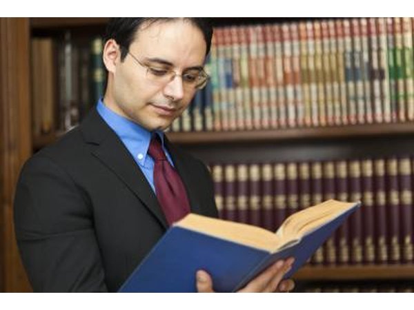 Lawyer reading from legal book