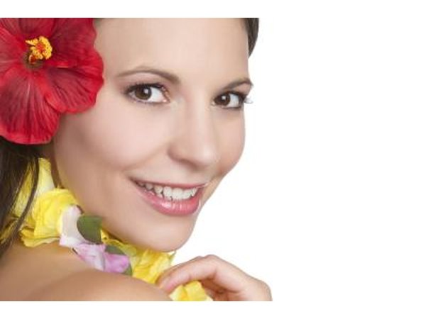 Smiling girl in Hawaiian attire.