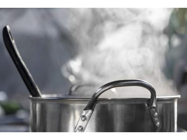 A steaming pot sits on the stove