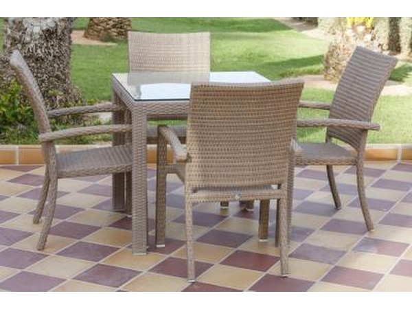 A table for four in an outdoor room with ceramic tile flooring.