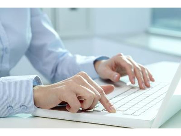 Close-up of hands typing on computer