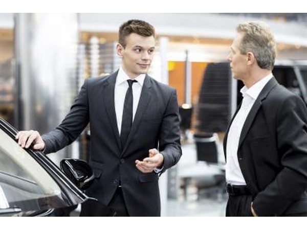 Car salesman talking to potential customer