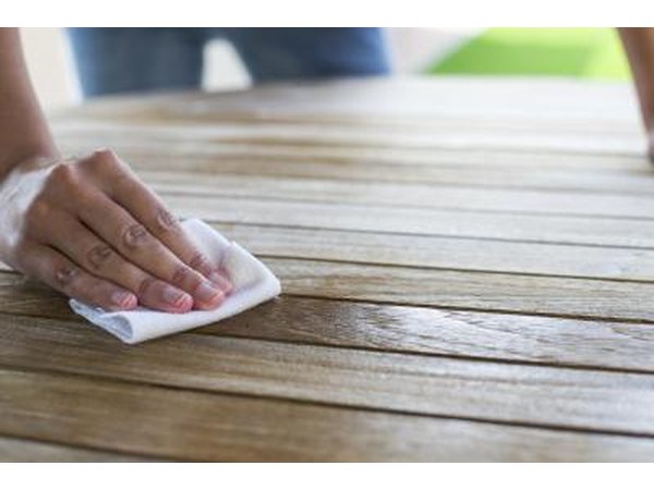 Woman applies oil to wood