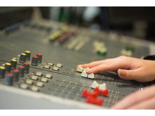 Hands working a mixing board