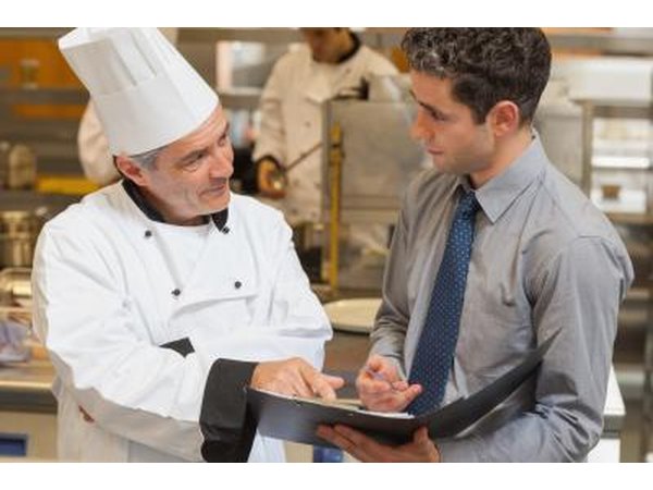 waiter and chef discussing a menu