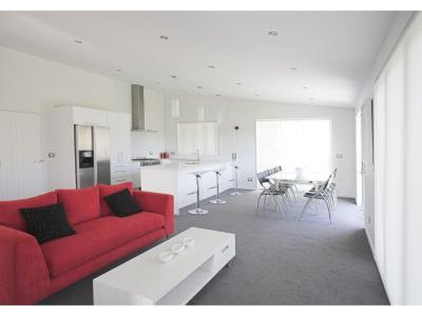 Open plan kitchen with bright couch for added focal point
