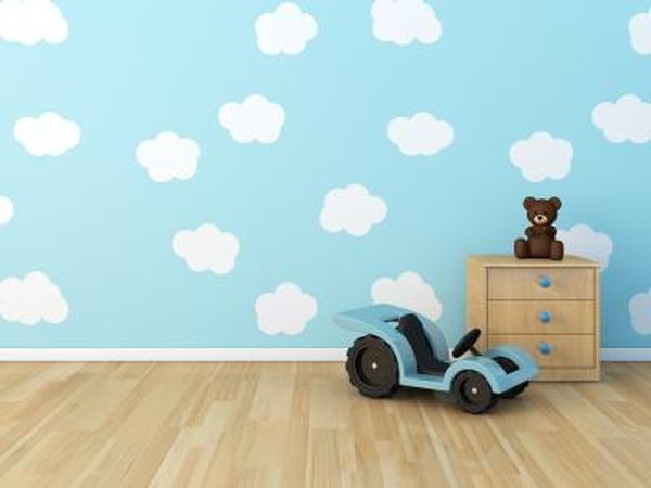 Clouds are painted onto the wall of a child's bedroom.