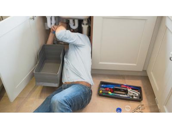 Man fixing sink pipe