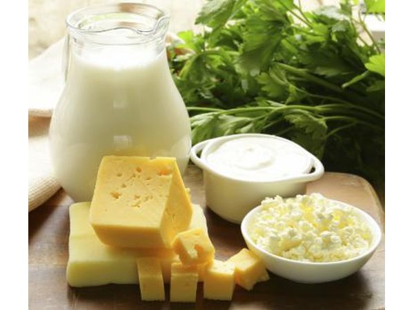 Various dairy products on a wood cutting board