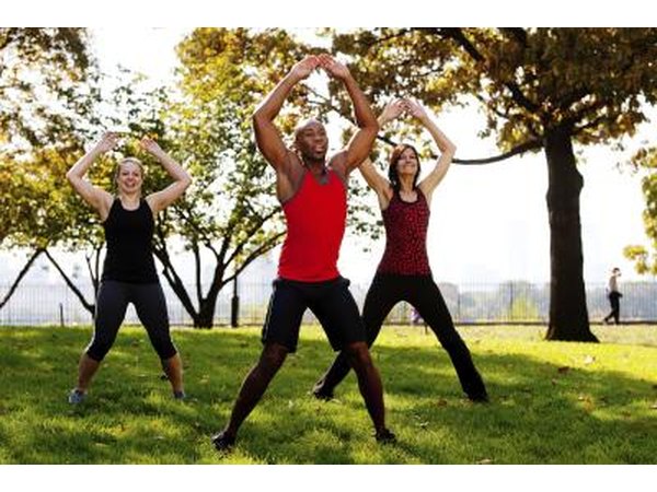 Young adults doing jumping jacks to stay active and warm