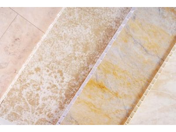 Four panels of vinyl floor samples lying next to one another for comparison.