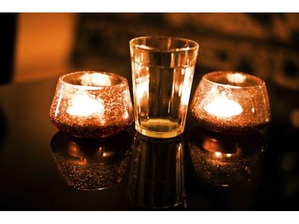 Floating candles in chocolate brown glasses will create a beautiful night time effect