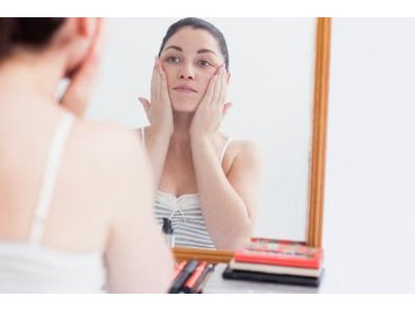 Use a mirror to locate the skin tag.